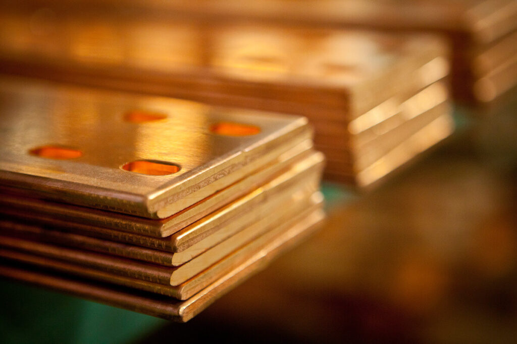 close up on thin sheets of copper that have been processed using Monti's copper machining services.